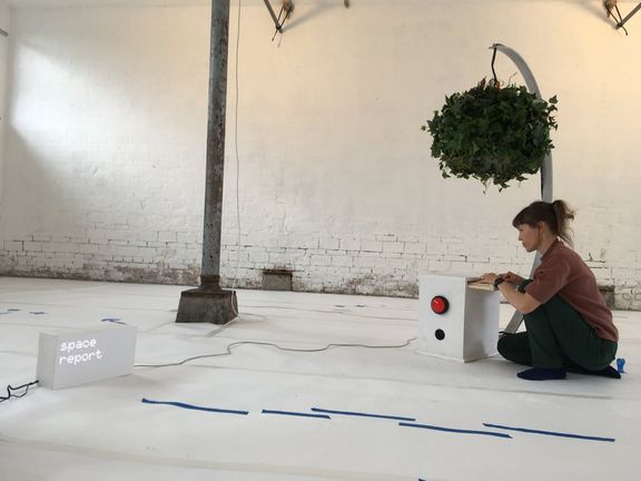 Lotta typing on a white box below a leafy recording helmet, and a LED matrix showing the text 'space report'